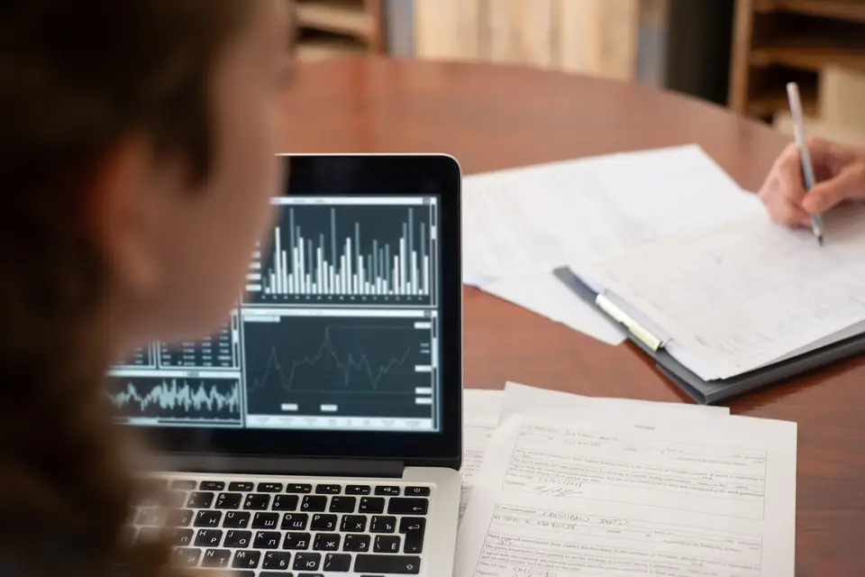 Analyst reviewing statistical charts on a tablet during a content review