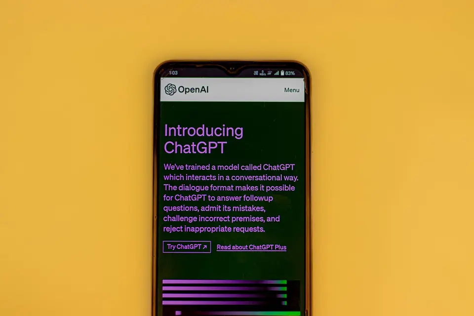 Phone showing an OpenAI announcement page for a conversational AI model