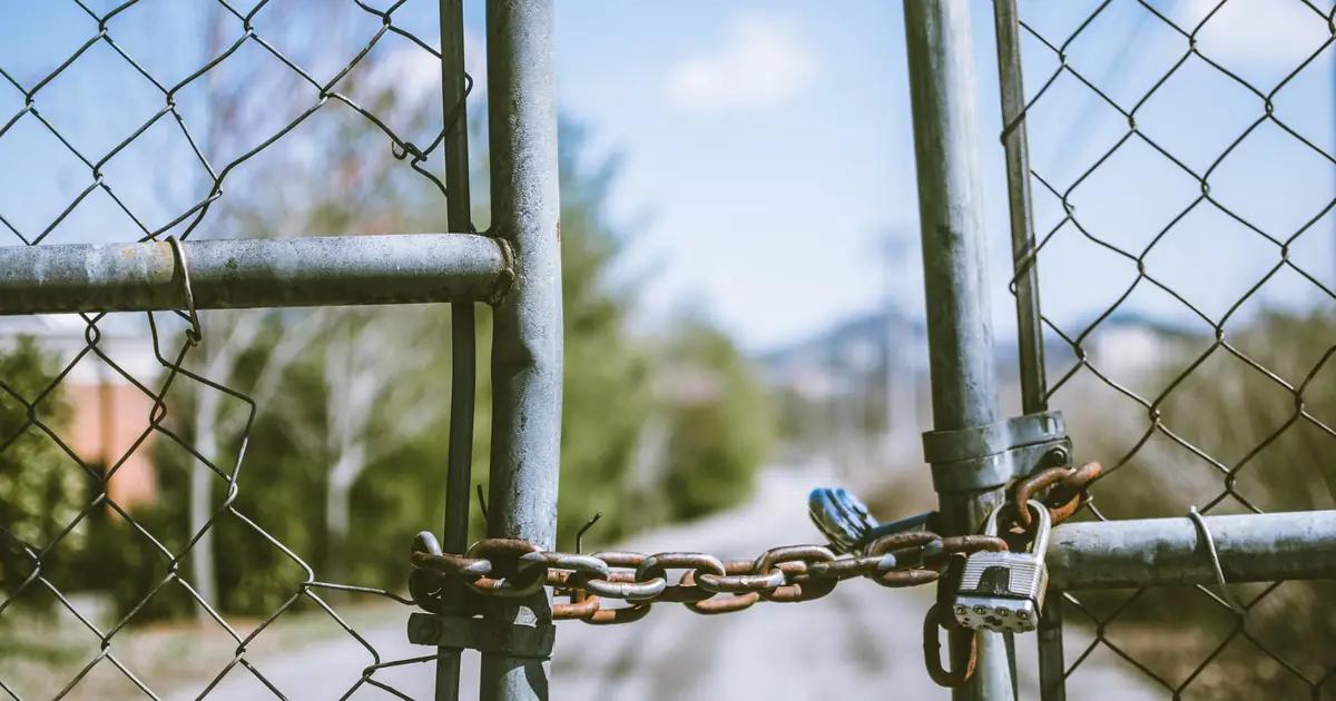 Chain and padlock securing a wire fence