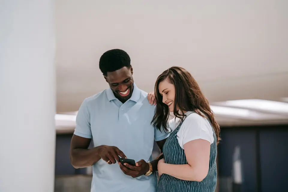 Two colleagues sharing something they found on a screen