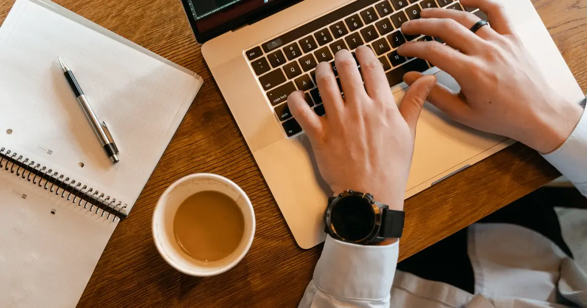 Writer drafting a long-form SEO article on a laptop