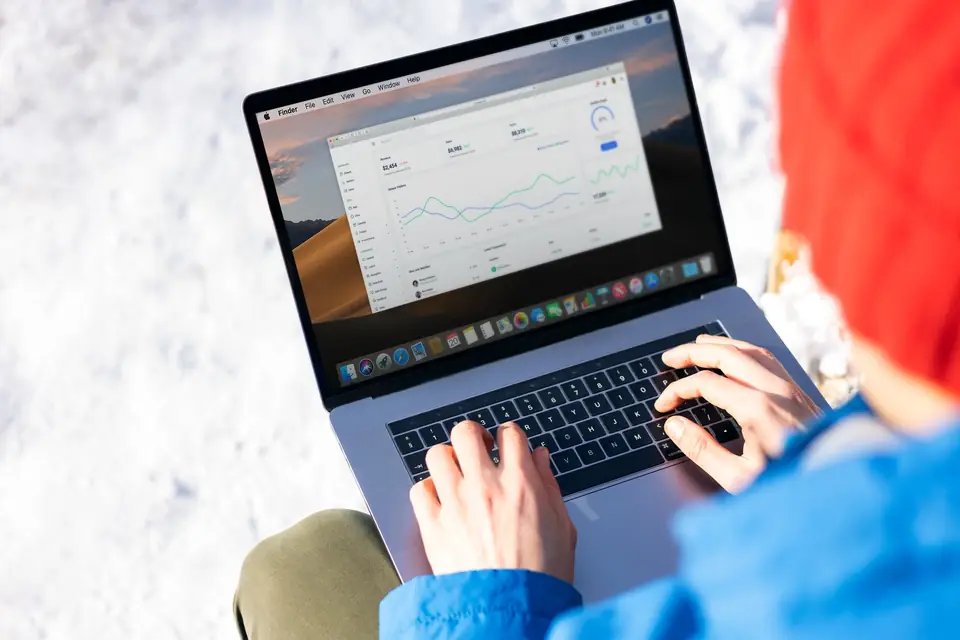Reviewing performance figures on a laptop