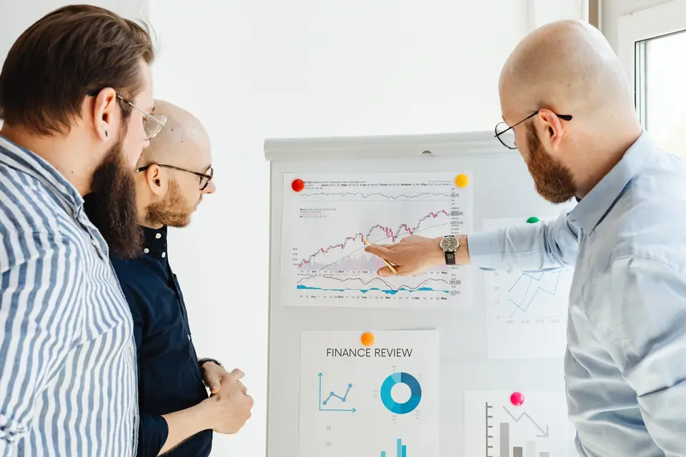 Team walking through a review chart on a whiteboard