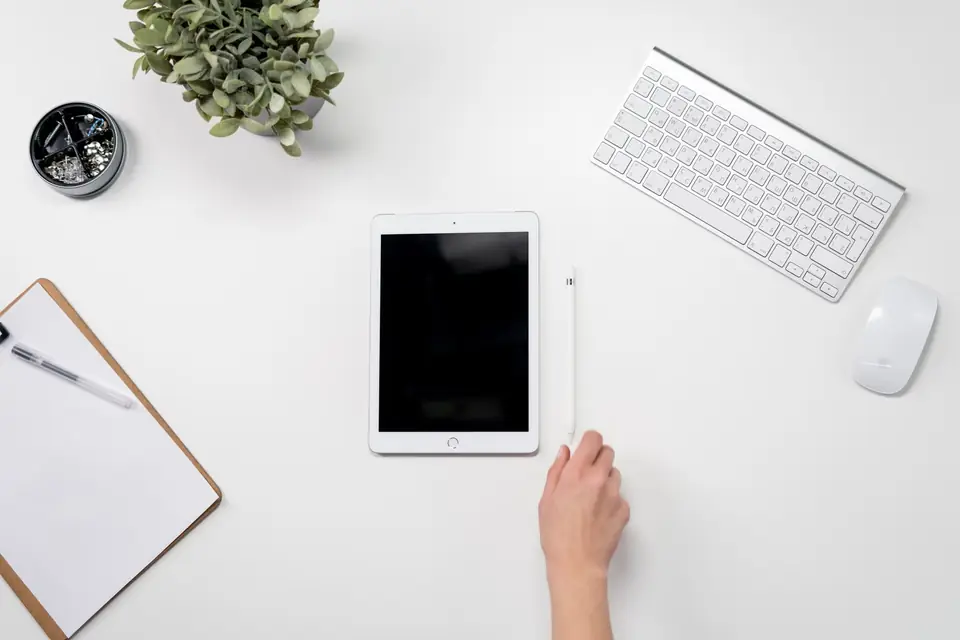 Tablet, keyboard and mouse laid out together on a desk